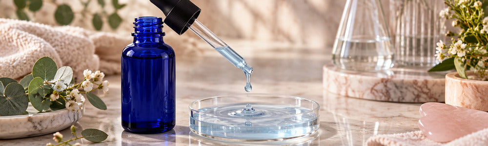 Cobalt serum dropper and blue serum texture in an elegant setting