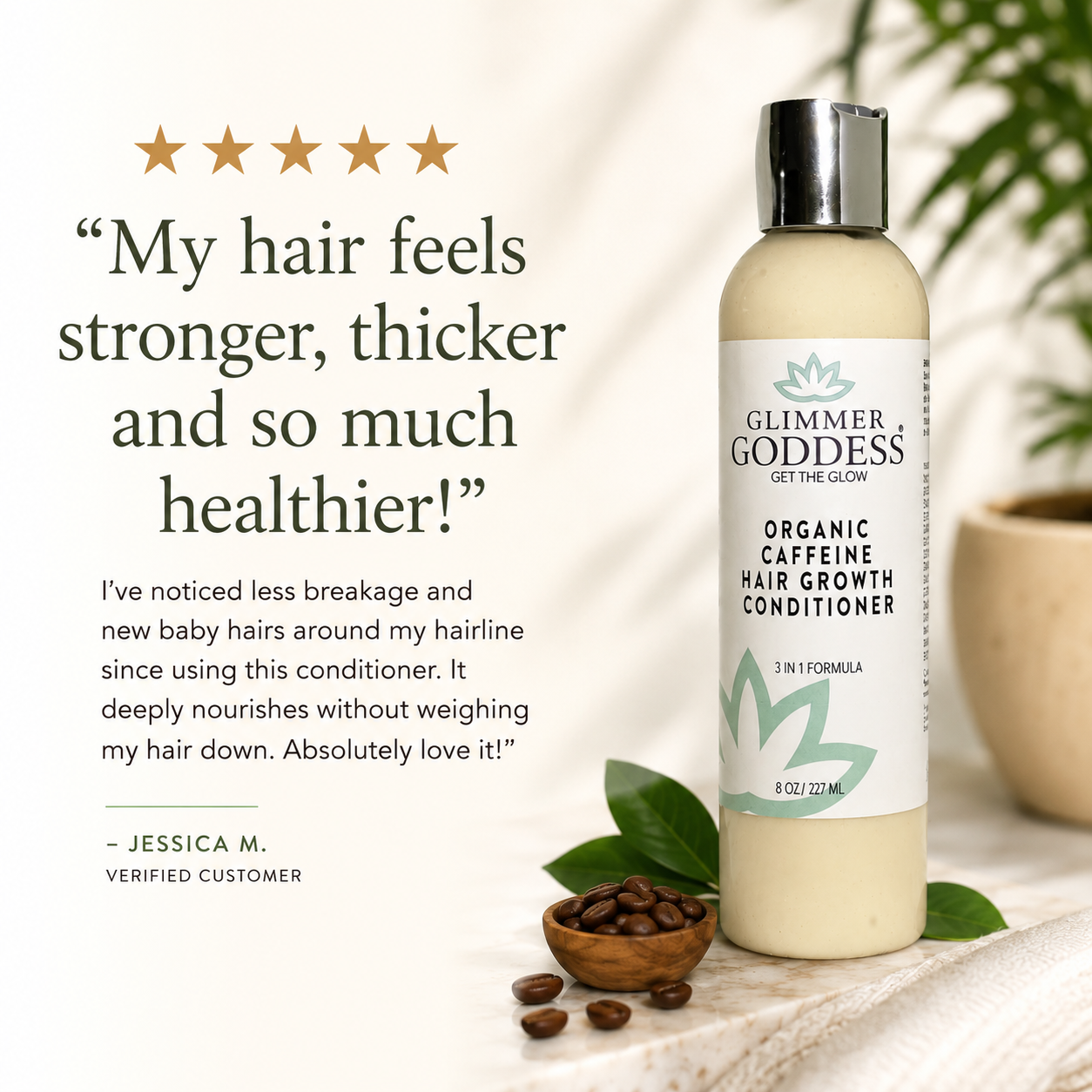 A bottle of Glimmer Goddess Organic Caffeine Hair Growth Conditioner stands on a light surface with coffee beans and green leaves around it. The bottle is cream-colored with a white label and silver cap.