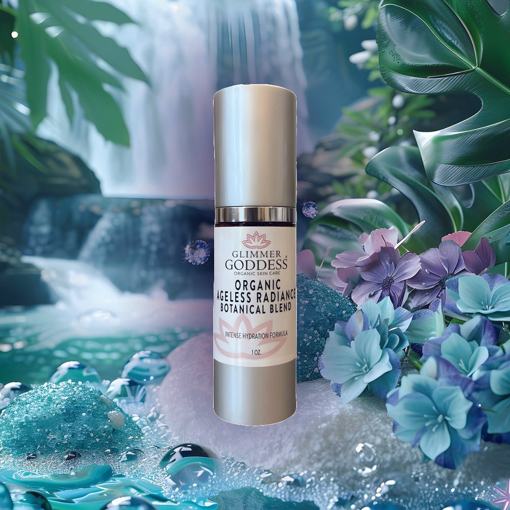 Organic Skin Brightening Serum from Glimmer Goddess bottle by waterfall and blue and purple flowers