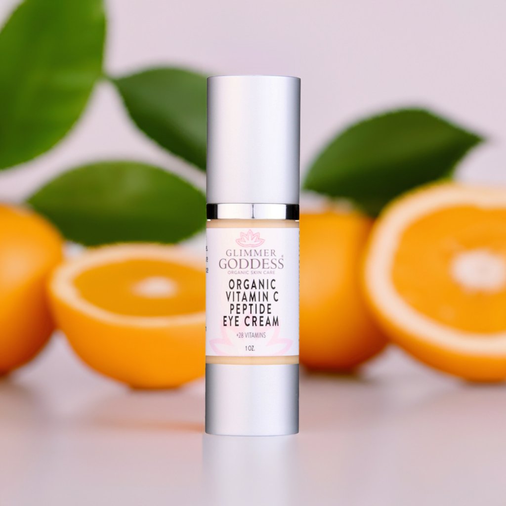 Organic Vitamin C Peptide Eye Cream with citrus and green leaves background