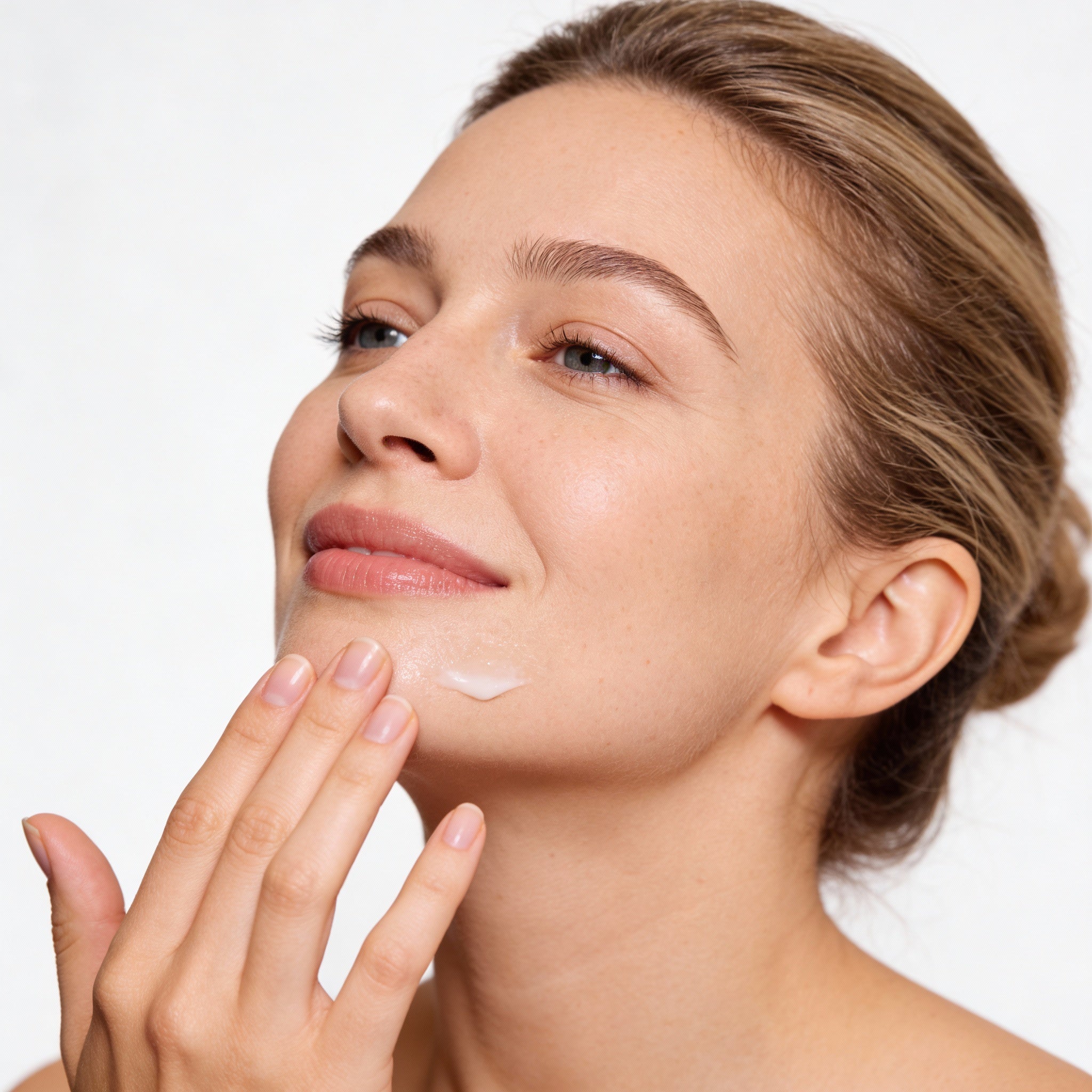 Woman applying serum to face