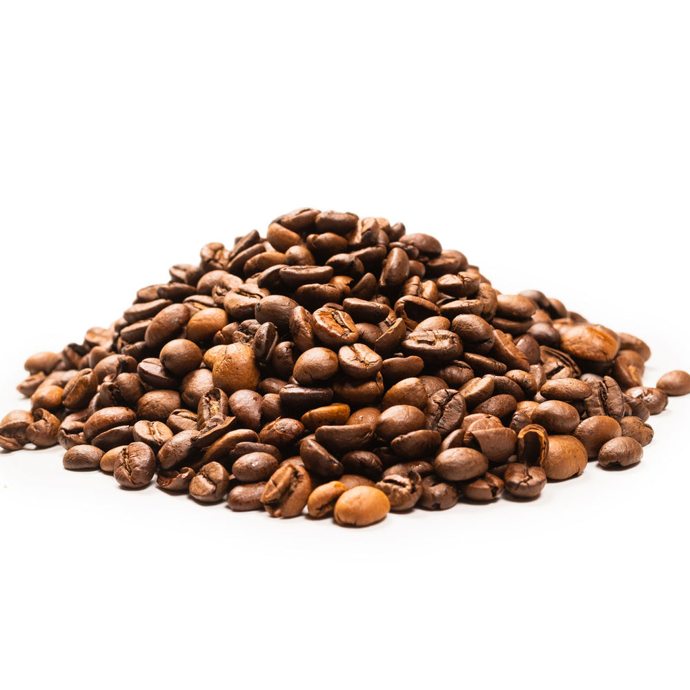 Pile of roasted coffee beans on white background, key natural skincare ingredient