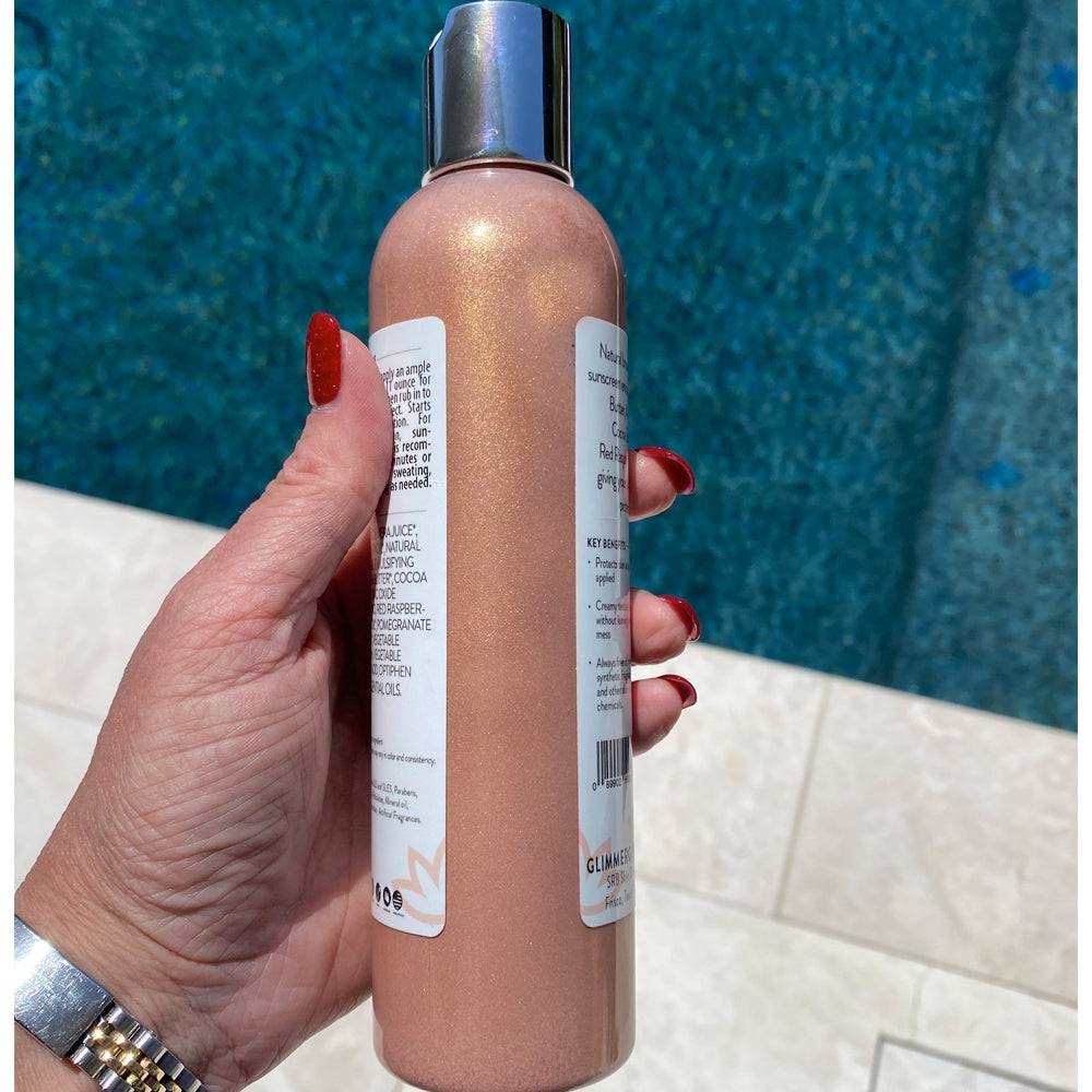 Woman holding Organic Shimmer Suntan Lotion from Glimmer Goddess®